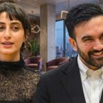 MAMDANI Sparks PANIC—Homeowners Scrambling to Escape… Two professionals engaged in conversation in a modern office setting