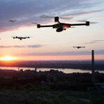 Drone SCARE Shuts Down – Leaders in Bunkers! Drones flying over a landscape at sunset.