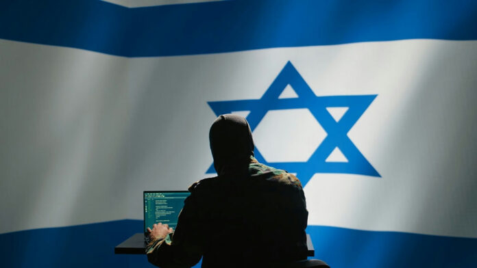 2481173299 Hacker in front of Israeli flag with laptop.
