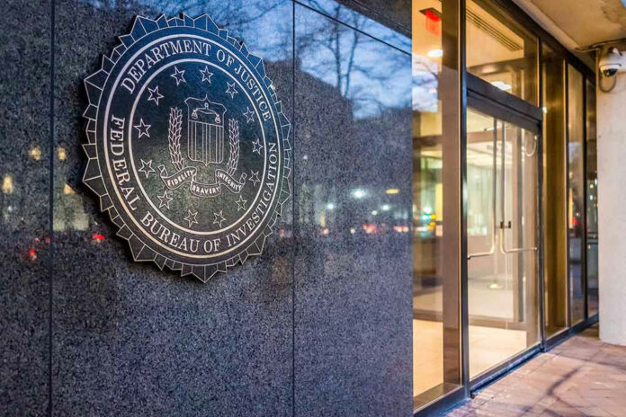 FBI seal on building wall near entrance doors.