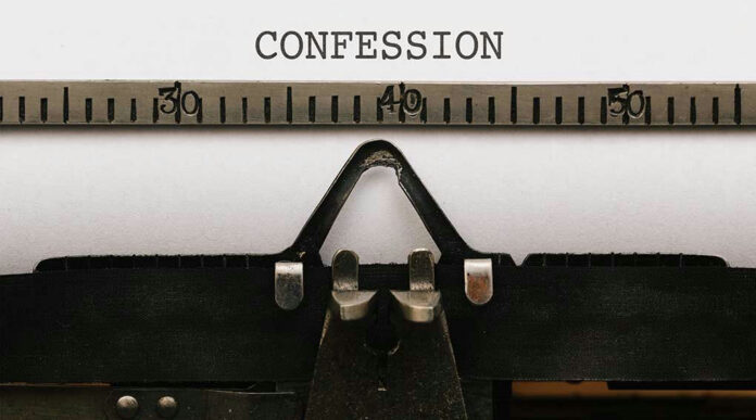 579321010 Typewriter with paper showing the word confession.