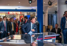 Tucker Carlson’s Holocaust Take Sparks OUTRAGE! news anchor at studio desk with crowd in background