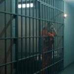 Bizarre Jail PLAN: Texas Candidate TARGETS Zionists! Two inmates in orange jumpsuits inside a prison cell