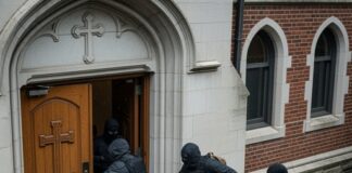 Masked individuals attempting to break into a church