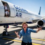 Airport SINKHOLE: Massive Travel Disruptions! A person joyfully celebrating near an airplane with crew members visible in the background