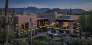 Desert home with outdoor seating and cacti in the foreground