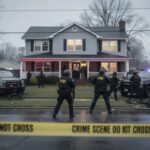 BUSTED: Man Threatened Massacre Over Hantavirus LOCKDOWNS… FBI agents at a crime scene outside a house with police vehicles and caution tape