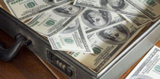 Open briefcase filled with one-hundred-dollar bills.
