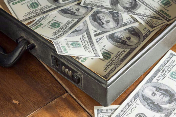 147514376 Open briefcase filled with one-hundred-dollar bills.