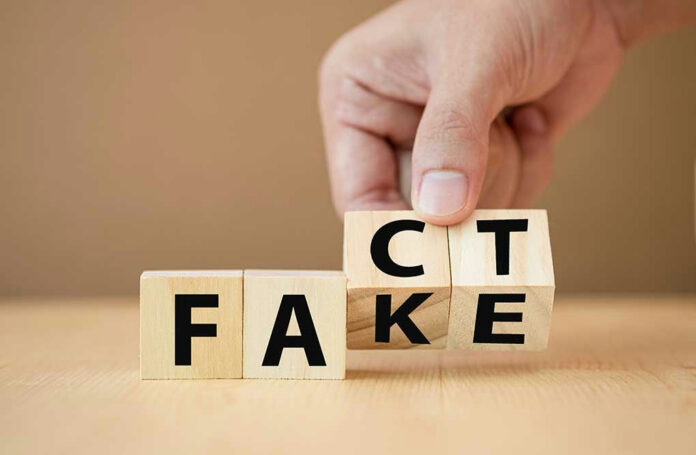 1549738514 Fact and Fake written on wooden blocks
