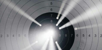 Target with multiple bullet holes and light rays.