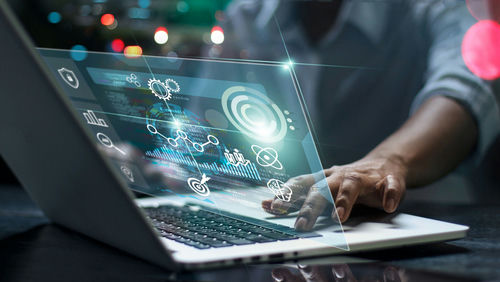 shutterstock1831742065jpg-1 Person using laptop with futuristic data and analytics interface