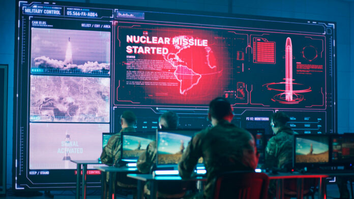 shutterstock1921312118jpg Military personnel monitor a command center screen showing missile launch alerts