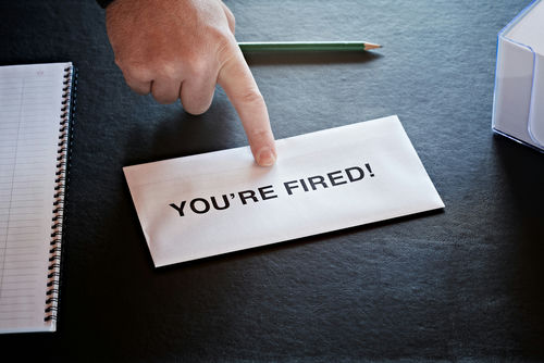 shutterstock70617409jpg Hand pointing to an envelope on a desk