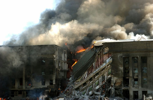 shutterstock_244394308 burning building with heavy smoke and collapsed sections