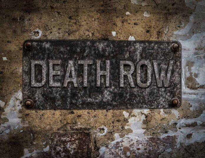 shutterstock_533872477-1- Aged metal sign reading Death Row on a weathered wall