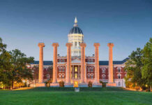 Historic building with columns at sunset, front view.