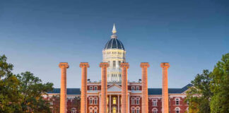 Historic building with columns at sunset, front view.