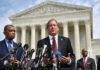 Residency Dispute puts on a Political Collision Course Men in suits speaking at podium outside courthouse.