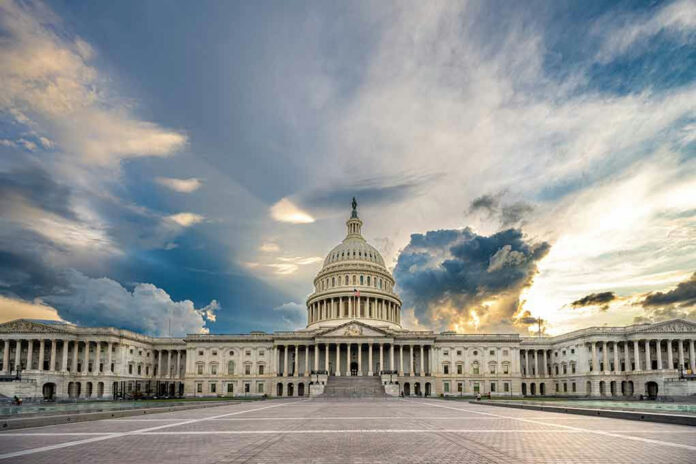 2110094846-1 U.S. Capitol building under a dramatic sky at sunset.