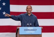 One Allegation Upended a Rising Senate Campaign Overnight Speaker at podium in front of large American flag