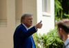 Man in suit giving thumbs up.