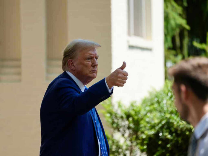 2475761689 Man in suit giving thumbs up.