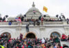 Only One Republican Broke Ranks on $3.3 Billion for Israel Crowd at U.S. Capitol building with flags and cameras.