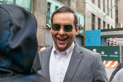 shutterstock_2284802545 Man in sunglasses smiling on a city street.