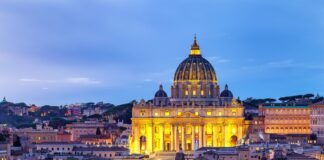 Illuminated St. Peter's Basilica in Rome at dusk