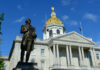 Governor Erases Murder Conviction New Hampshire State House with statue in foreground.