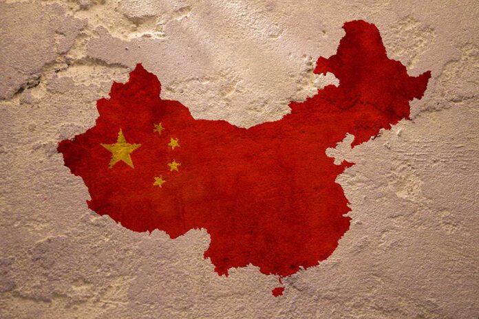 China's map with flag painted on textured wall.