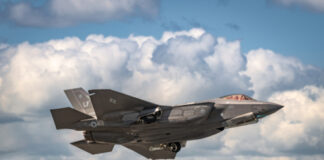 F-35 fighter jet taking off from runway.