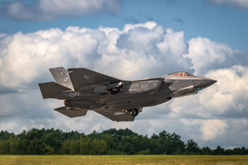 F-35 fighter jet taking off from runway.