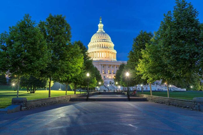 The U.S. Capitol building illuminated at night.