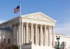 United States Supreme Court building with American flag.